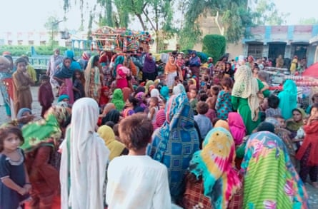 Women gather to receive aid in the aftermath of the 2022 floods.