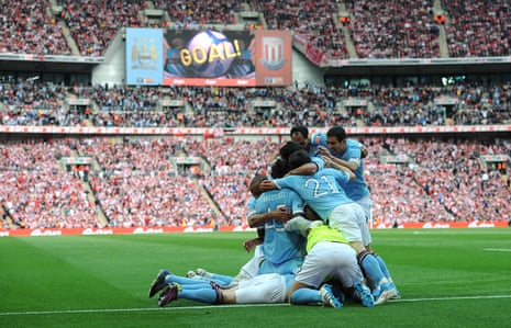 Yaya Touré is mobbed by his teammates after he scored the opening goal of the game during the 2011 FA Cup final