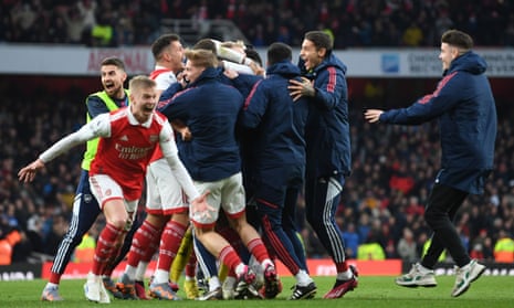 Arsenal staff come on to the pitch to celebrate Reiss Nelson’s winner