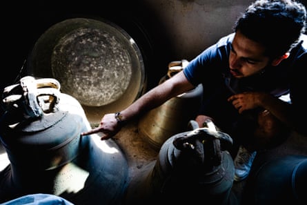 Youssef Naffah points to a mark on an old bell.