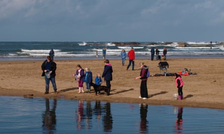 Family playing at the beach during the Autumn half term, Bude