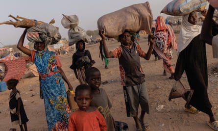 Refugees from Darfur in Sudan head to shelters in Adre, Chad, in April.