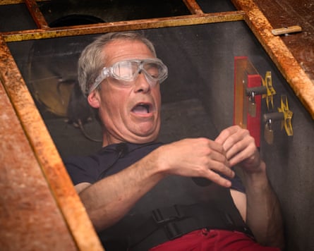 Nigel Farage lying in a small chamber wearing goggles