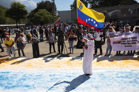 Person holds up a Venezuela flag