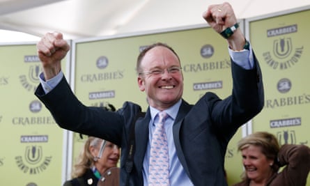 The horse trainer Dr Richard Newland celebrates a victory at Aintree.