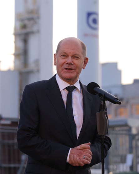 Olaf Scholz speaking into a microphone at an outdoor event