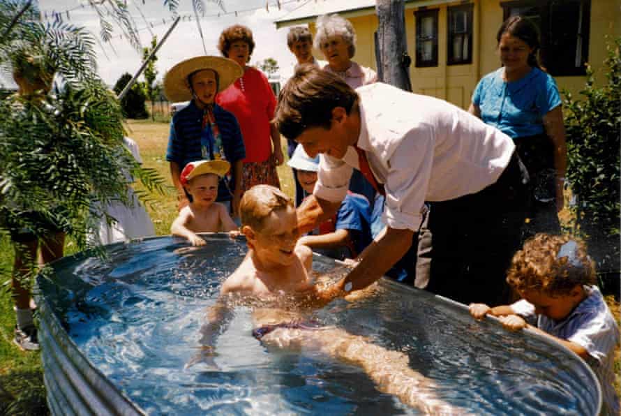 Tom Tilley, 10, being baptised by his father
