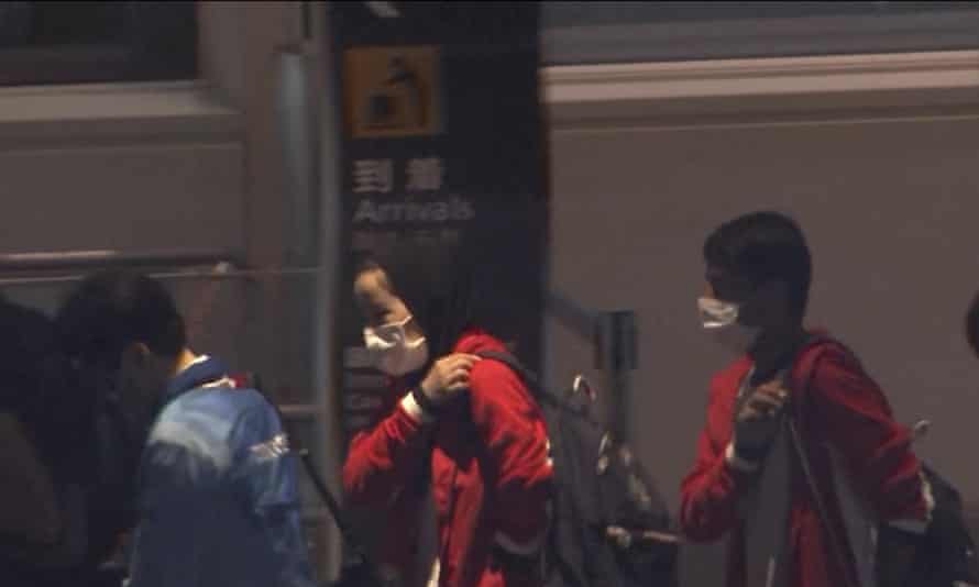 Afghan athletes Zakia Khudadadi, center left, and Hossain Rasouli, center right, arrive at Haneda airport in Tokyo.