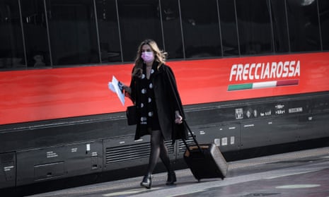 A passenger in a railway station in Milan on Friday