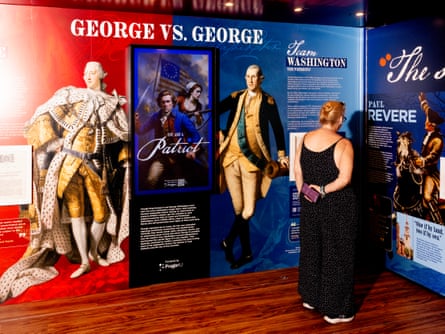 People look at an exhibit titled George vs George