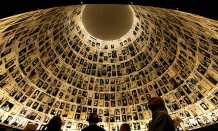 Visitors look at Holocaust pictures at the Hall of Names at the Yad Vashem museum, Jerusalem.
