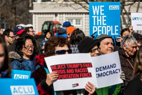 people hold signs against Donald Trump