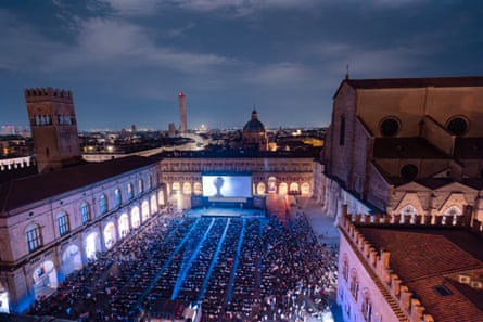 Aerial view of packed square with cinema screen