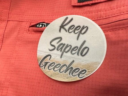 A sticker saying “Keep Sapelo Geechee” connected reddish cloth