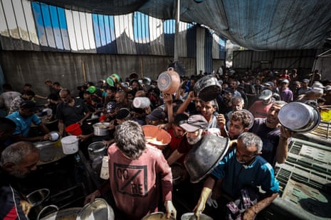 Palestinians, mainly children, crowd the food distribution point of a charity organization in Nuseirat, Gaza, earlier this week.