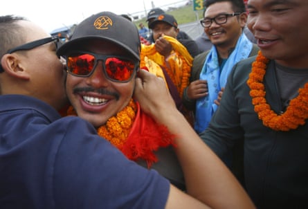 A man hugs Purja as others stand around them smiling
