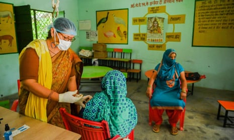 A woman is vaccinated with Covishield at a health centre in Sultanpur, Uttar Pradesh