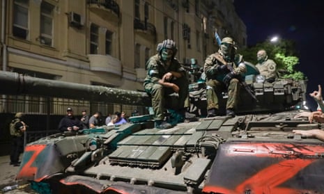 Membes of the Wagner Group military company sit atop of a tank on a street in Rostov-on-Don, Russia, Saturday, June 24 2023.