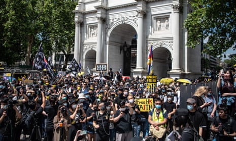 Protesters attend a rally at Marble Arch in London calling for democracy in Hong Kong