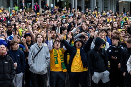 A few of the large crowd of Socceroos fans in Federation Square as they watch the World Cup game