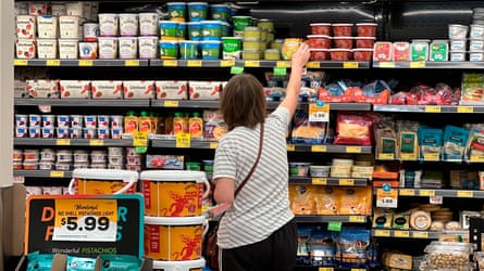 A woman reaching for groceries in a store