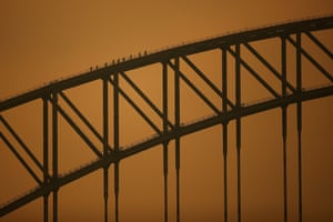 People climb the Sydney Harbour Bridge during a BridgeClimb guided tour