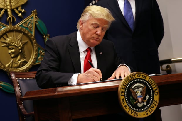 Donald Trump signing the executive order to impose tighter vetting of travellers entering the USA