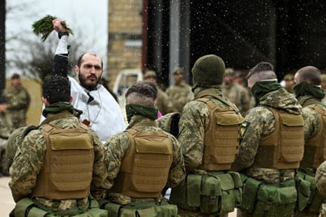 A Ukrainian Orthodox priest blesses the members of the Armed Forces of Ukraine at a training base near Salisbury, Britain.