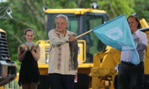 The President of Mexico, Andres Manuel Lopez Obrador, waves a flag during an event to mark the start of work on the fourth section, Izamal-Cancun, of the Mayan Train, in Lazaro Cardenas, Quintana Roo, Mexico, 1 June 2020.