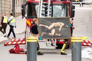 Firefighters transporting art pieces to safety