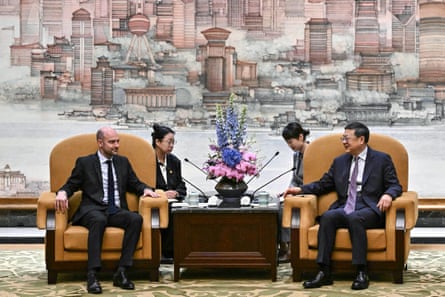 The two politicians sit in large armchairs