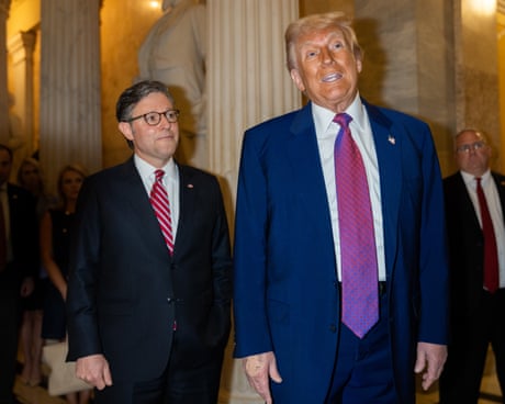 two men in suits standing next to each other