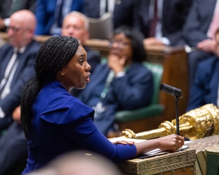 Kemi Badenoch speaks at PMQs. She wears a royal blue jacket and is seen in profile.