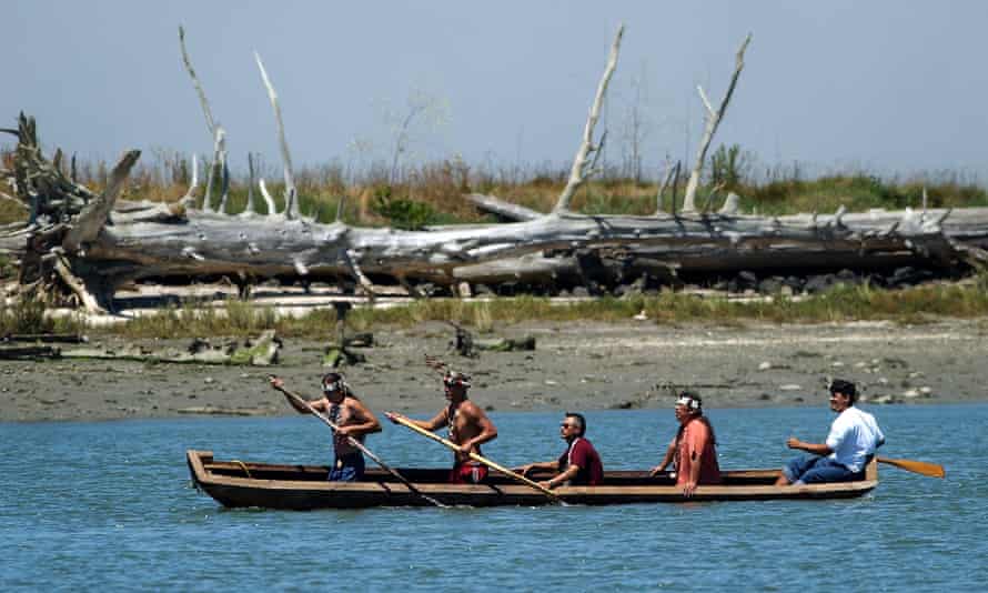 Members of the Wiyot Tribe paddle a redwood canoe in Eureka, California, as part of a ceremony where the city relinquished possession of 40 acres of land previously occupied by the Wiyots in 1860.