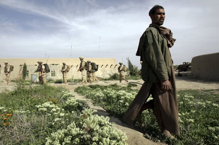 British soldiers passing a farmer in Musa Qala, March 2006