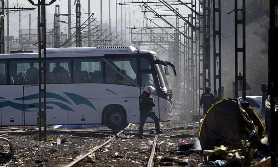 A bus carrying refugees heads from the Idomeni border crossing in northern Greece to one of two stadiums in Athens.