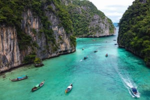 Tourists entering Pi Leh Bay on Thailand’s Phi Phi Leh island in longtail boats