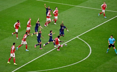 Arsenal's Bukayo Saka in action as Paris St Germain players react.