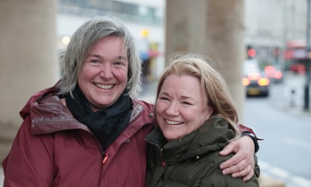 Midshot of Tracey with arm around Lisa, both smiling