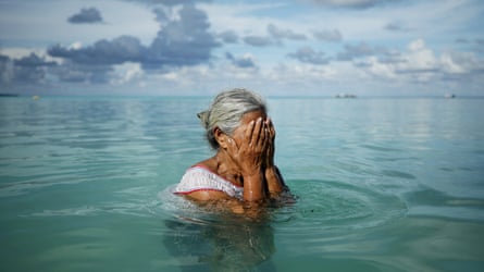 A woman stands in a lagoon