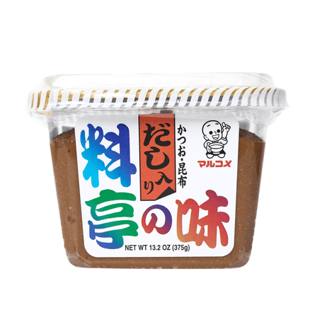A clear plastic container of brown miso paste with a colourful Japanese-labelled sticker