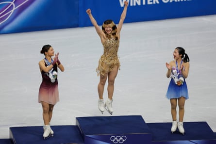 Alysa Liu celebrates on the podium alongside fellow medalists, Kaori Sakamoto and Ami Nakai.