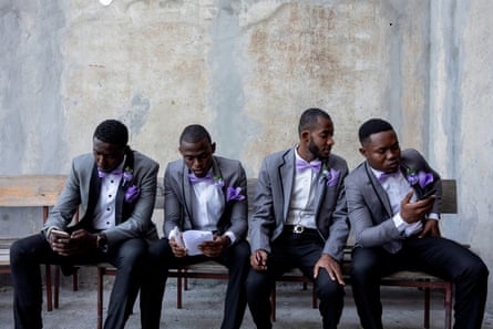 Boys of honour Victor Rulx Guilbert, 25, Lucien Hasting, 27, Jean Louis Fabrice Guerlens, 25, and Edouard Wonder, 27, at the wedding of Stanley and Daphne Joseph, wear matching suits as part of Haitian marital tradition, as they wait for the ceremony to commence, at a church in Port-au-Prince