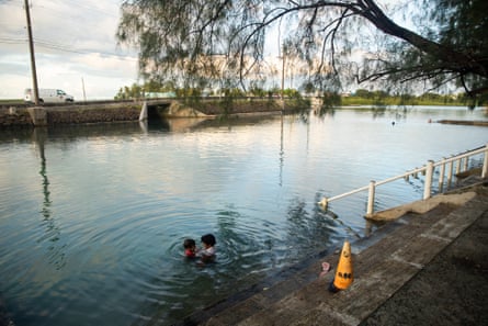 Two people swimming in a human-made lagoon