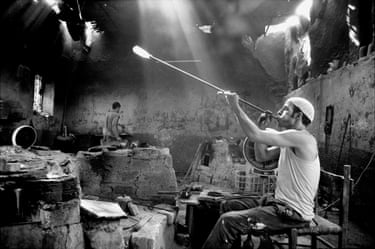 City of the Dead 1993In Cairo, refugees from the housing shortage have laid claim to the city’s main cemetery. One hundred and twenty thousand people live, work, shop and go to school in and among the mausoleums. It is a thriving necropolis where the sanctity of the dead coexists with the needs of the living. A glass factory is one of the many small industries that thrive in the cemetery.