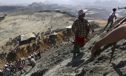 Miners search for jade stones at a mine dump at a Hpakant mine