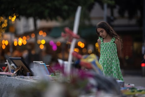 A girl looks at pictures of hostages kidnapped during the 7 October Hamas attack, at Dizengoff Square in Tel Aviv, on Friday.