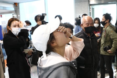 Relatives of missing people weep at a community service center on October 30, 2022.