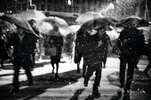 Untitled: Umbrellas on the streets of Tokyo during a snowstorm, captured with a slow shutter speed.
