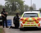 Armed police guard a roadblock near RAF Fairford airbase in Gloucestershire